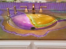 Glass sink on a mosaic countertop