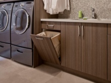Pedestal with a sink and a laundry basket. 