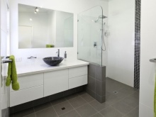 White hanging cabinet with black overhead bathroom sink
