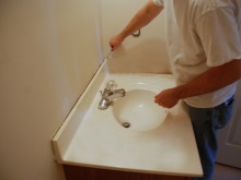 Installing a countertop and a sink on a makeshift cabinet in the bathroom