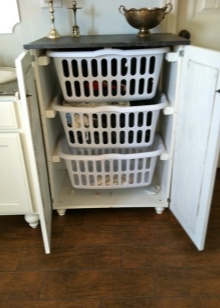 Bathroom cabinet with three plastic baskets for sorting dirty laundry