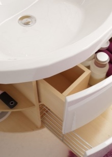 Bathroom sink cabinet with pull-out laundry basket and drawer for bathroom accessories 