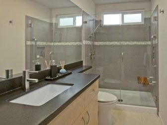 Glass shower enclosure for rectangular bathroom