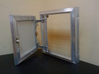 Metal bathroom access hatch under the tile in the bathroom