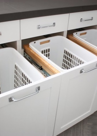 Fiberboard bathroom cabinet with three sliding baskets for sorting dirty laundry