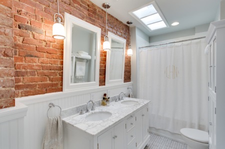 Brick wall in white bathroom