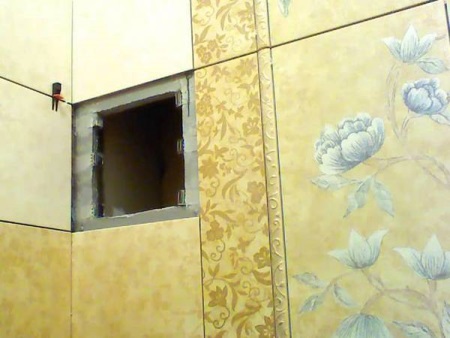 Makeshift magnetic invisible plumbing hatch in the bathroom