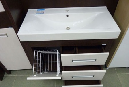Wooden bathroom vanity with built-in laundry basket