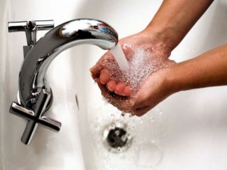 Running water from the faucet - testing the faucet and wash basin